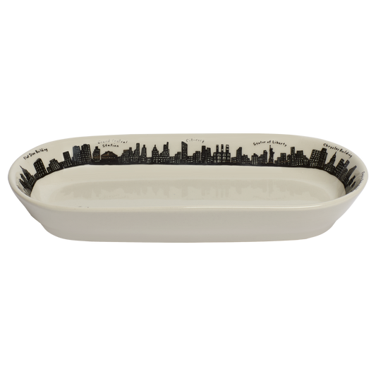 Rectangular ceramic dish with black city skyline design on a white background