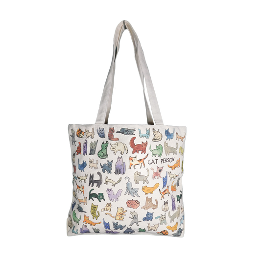 A medium-sized tote bag featuring a variety of colorful cat illustrations, with the text 'AT PETCO' on the bottom. The bag is primarily beige in color and has two white handles.