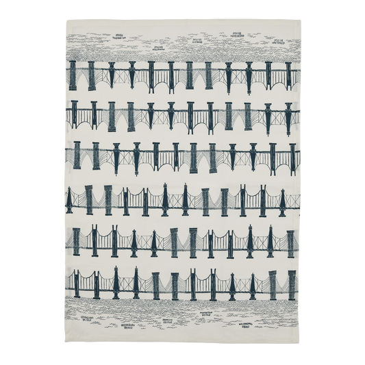 Full view of the Bridges tea towel with repeating navy bridge illustrations and labeled NYC bridges on white cotton