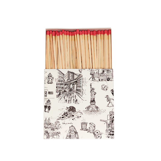 Matches with a decorative box featuring illustrations on a white background