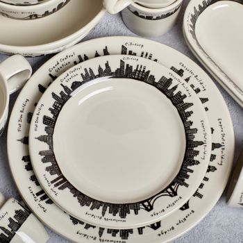 Dishware set with black city skyline design on a light background
