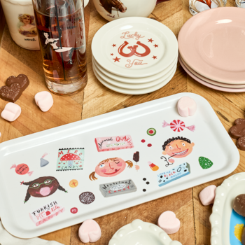 Placemat with cartoon designs on a wooden table with plates and glasses.