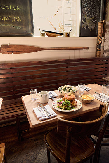 Dining table with a meal setup in a rustic restaurant setting.
